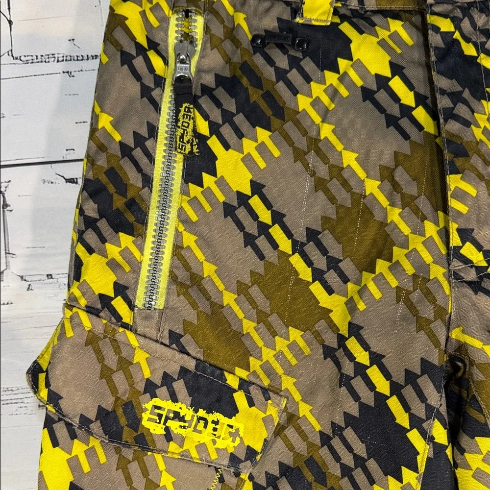 SPYDER Boys' Propulsion ski pants with an olive, black, and yellow plaid pattern